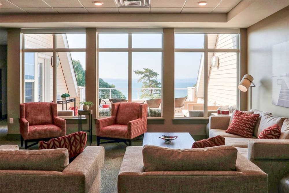 Clubhouse lounge with bay windows at Pinnacle North Apartments in Canandaigua, New York