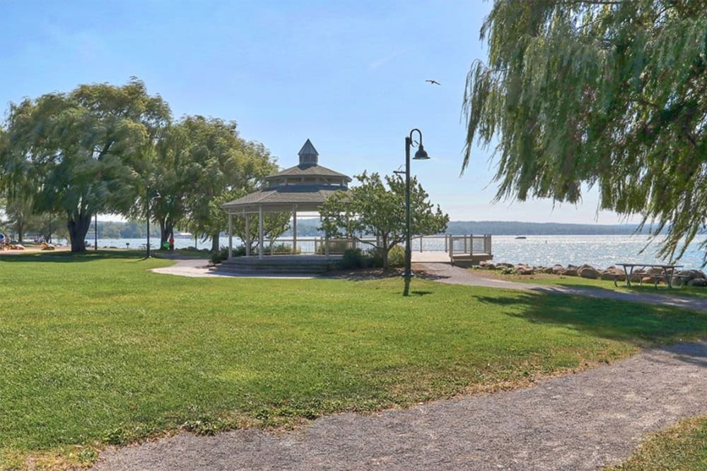 Gazebo surrounded by green grass near the beach at Pinnacle North Apartments in Canandaigua, New York