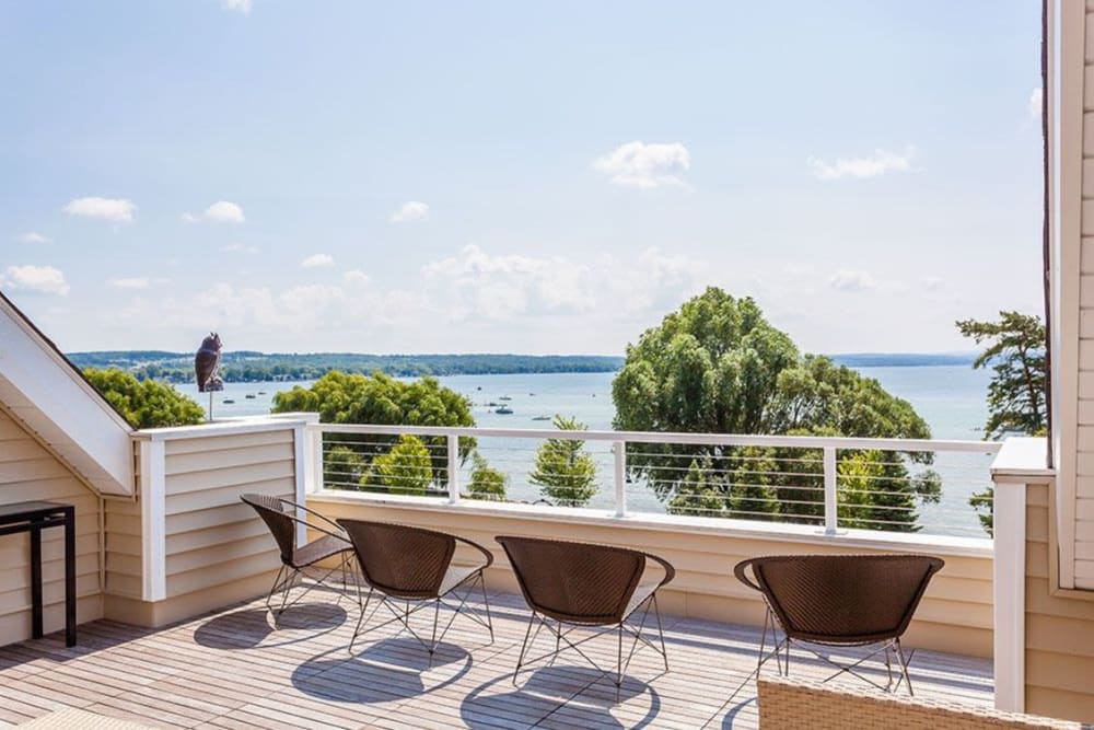 Bar seating at the outdoor clubhouse lounge overlooking the water at Pinnacle North Apartments in Canandaigua, New York