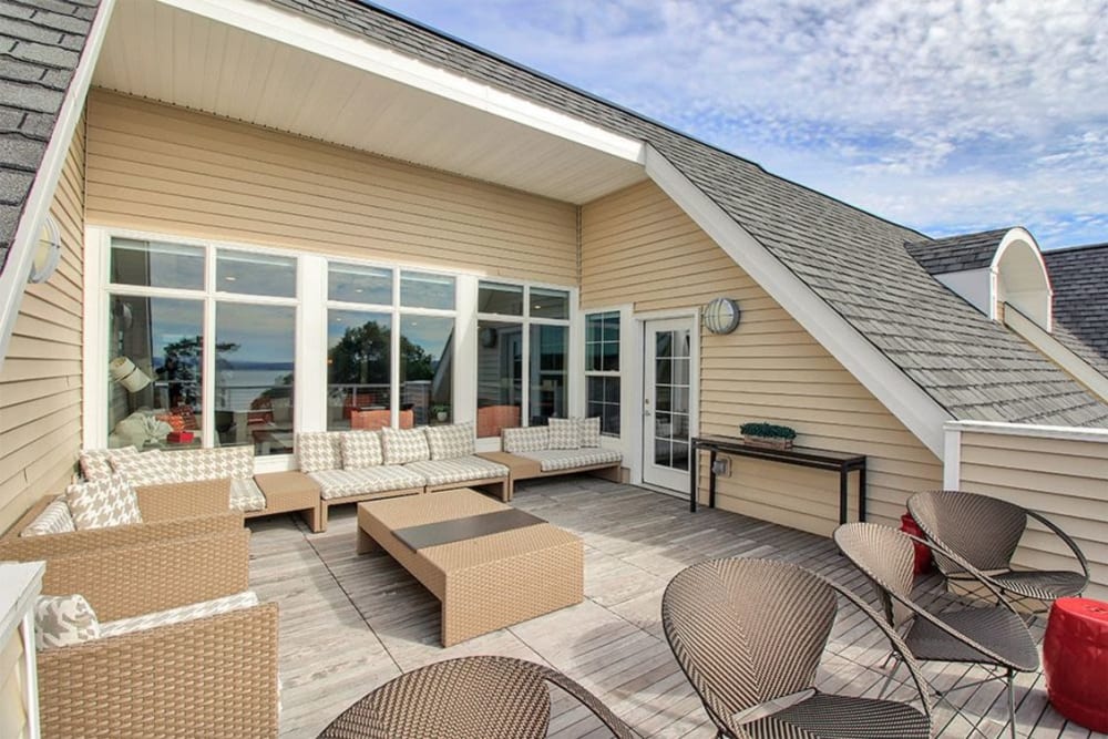 Plenty of comfortable places to relax and enjoy the view at the outdoor clubhouse lounge at Pinnacle North Apartments in Canandaigua, New York