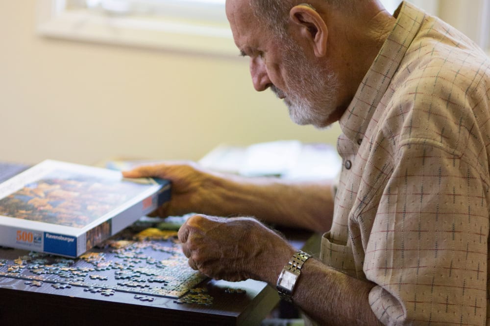 A resident putting together a puzzle at Gables of Ojai in Ojai, California