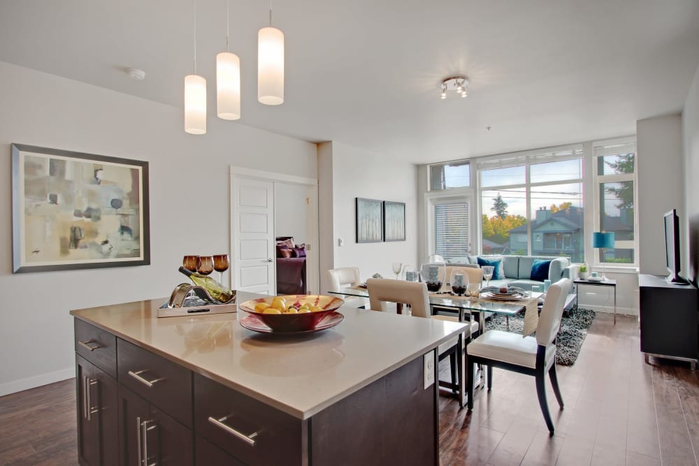 Open living and dining area with hardwood-style floors and plenty of natural light at Motif Apartments in Lynnwood, Washington