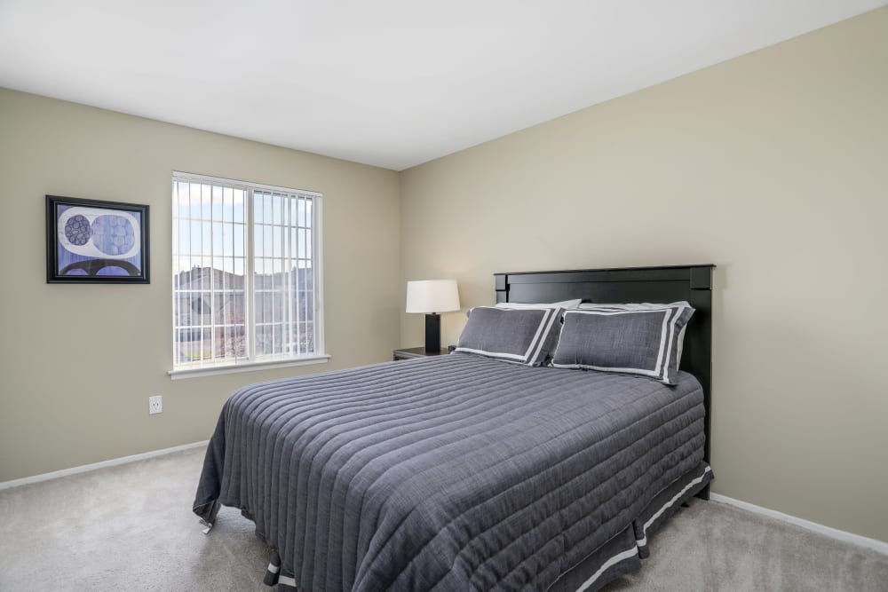 Model bedroom with gray accents at Town Court in West Bloomfield, Michigan