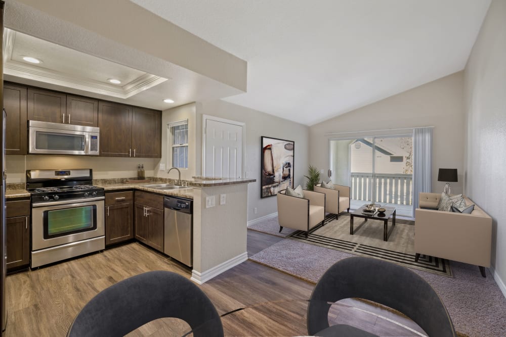 A renovated kitchen with espresso cabinetry dining room and living room at Village Oaks in Chino Hills, California