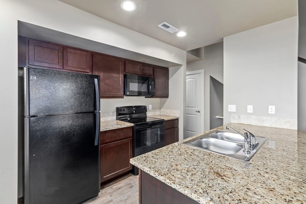 Model kitchen with granite countertops at Cedar Park & Canyon Falls Townhomes in Twin Falls, Idaho