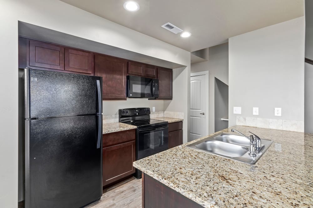 Kitchen with granite countertops at Cedar Park & Canyon Falls Townhomes in Twin Falls, Idaho