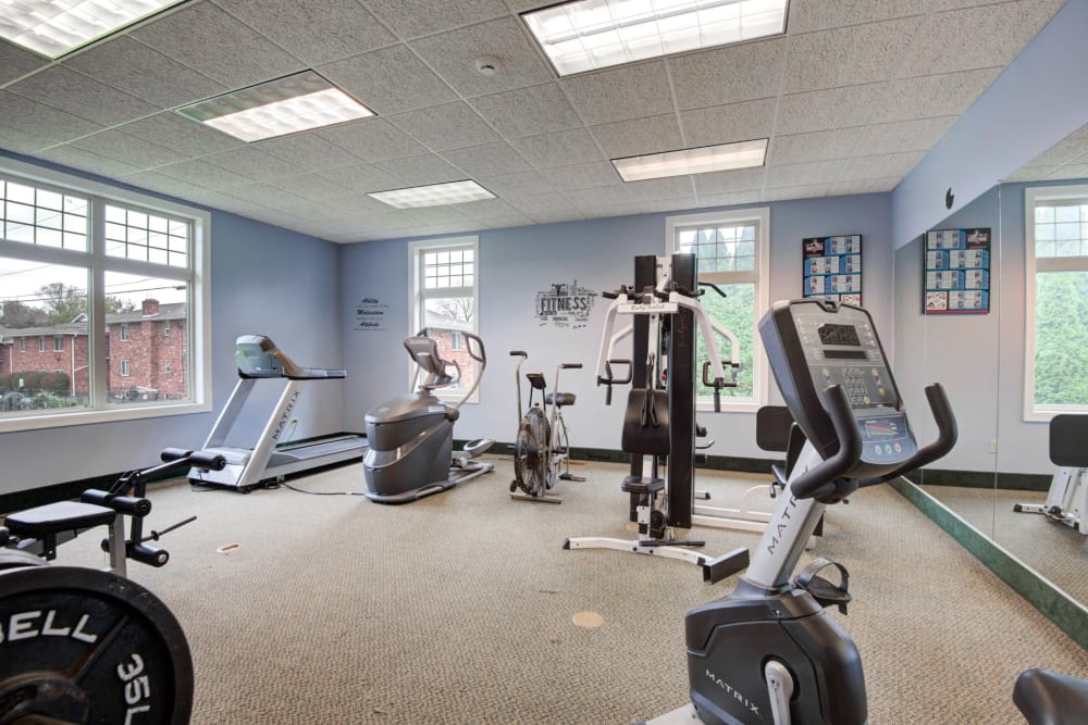 Fitness center with exercise equipment at Knollwood Manor Apartments in Fairport, New York