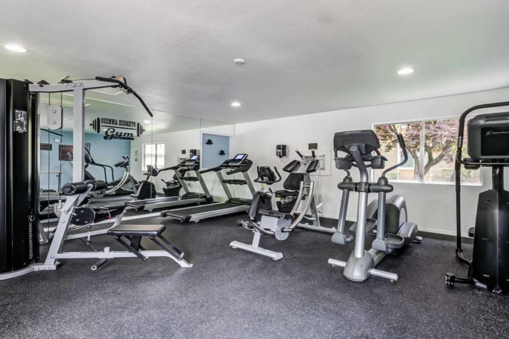 Big workout room full of modern equipment at Sienna Heights Apartments apartment homes in Lancaster, California