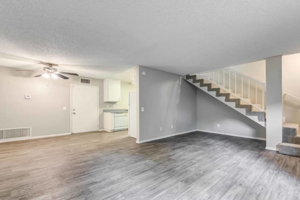 Open concept living room with stairs to second floor at Sienna Heights Apartments in Lancaster, California