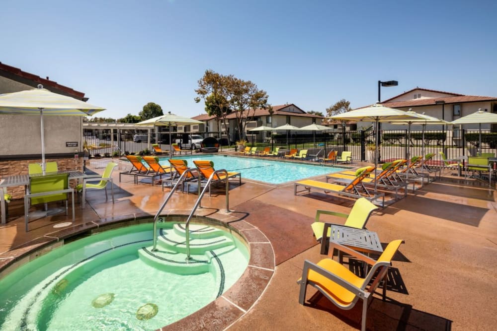 Large in-ground pool and hot tub at Cassia Apartments in Santa Maria, California