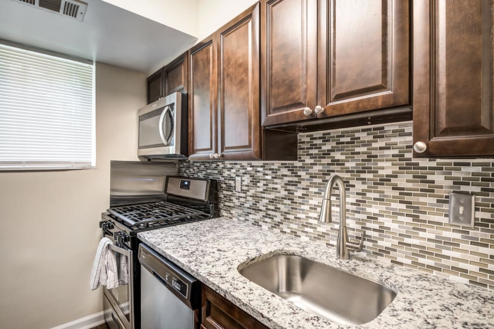 Kitchen with black appliance at Northwest Crossing Apartment Homes in Randallstown, Maryland