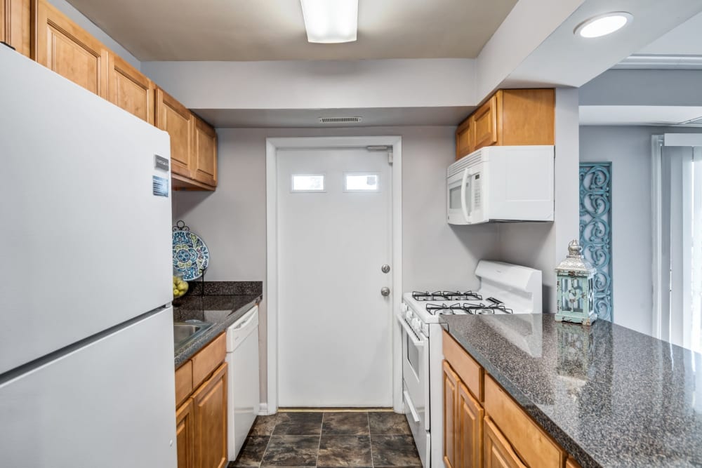 Kitchen with white appliance at Northwest Crossing Apartment Homes in Randallstown, Maryland