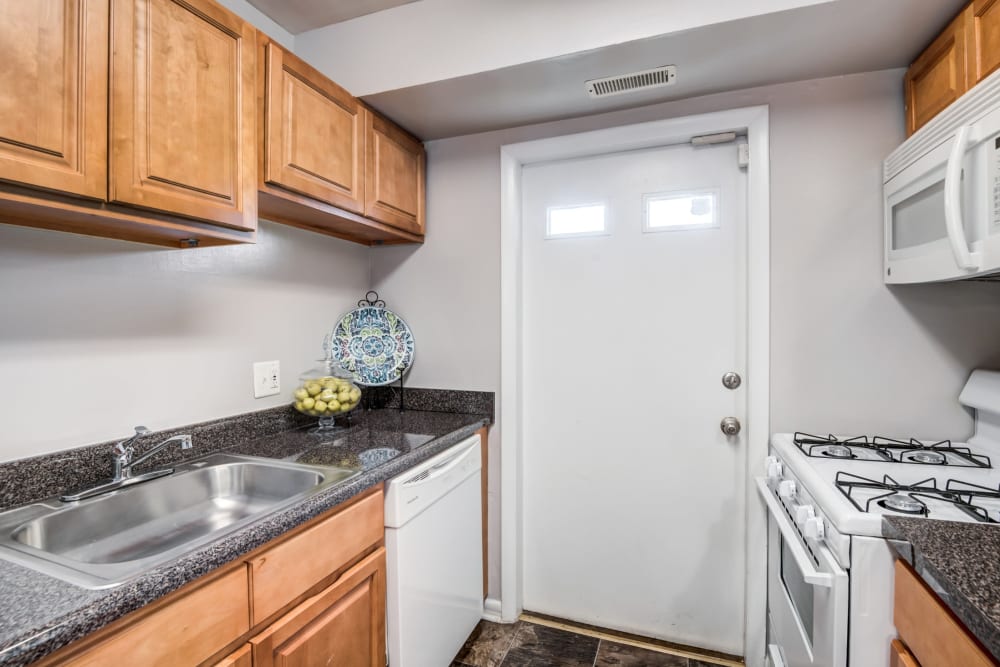Kitchen with white appliance at Northwest Crossing Apartment Homes in Randallstown, Maryland