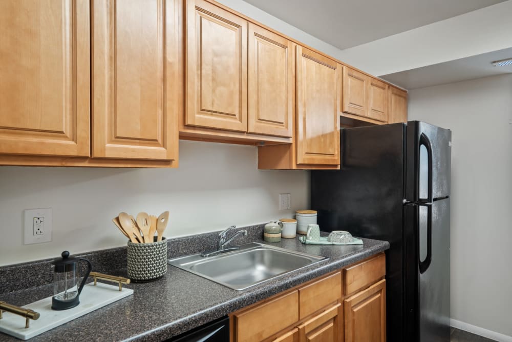 Cedar Gardens and Towers Apartments & Townhomes offers a kitchen with black appliance in Windsor Mill, MD