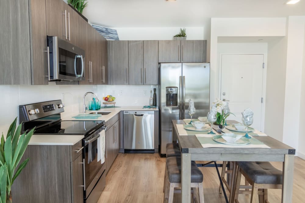 Kitchen with wood flooring and dark cabinetry at 275 Fontaine Parc in Miami, Florida