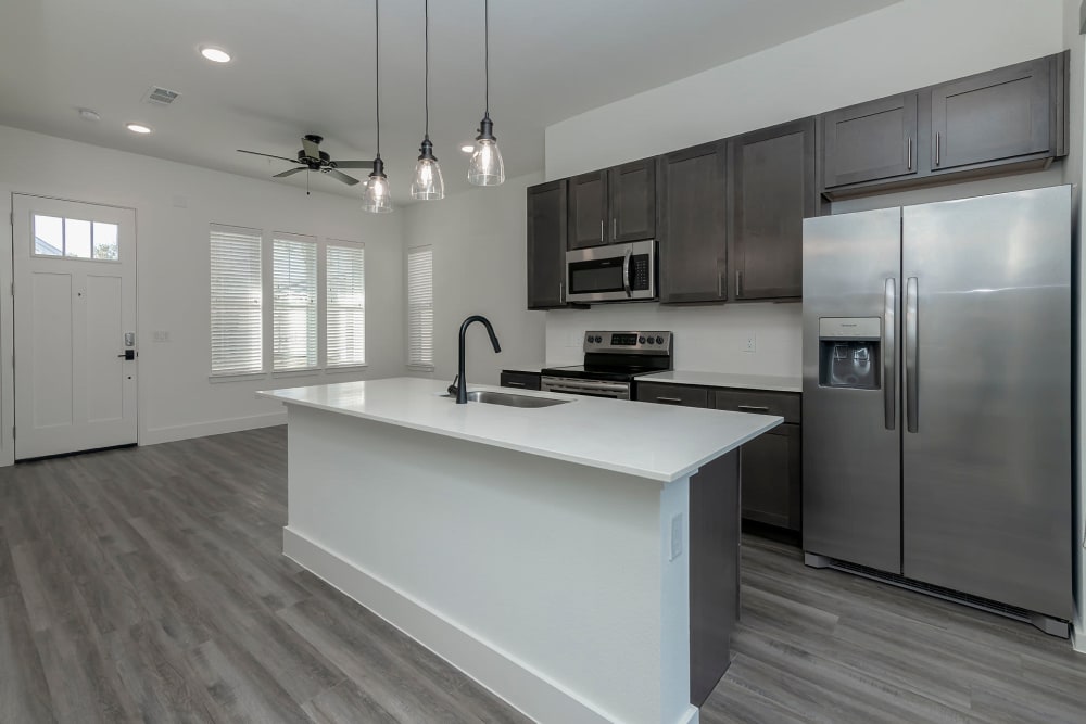 Kitchen with an island and stainless-steel appliances at Elevate at Skyline in McKinney, Texas