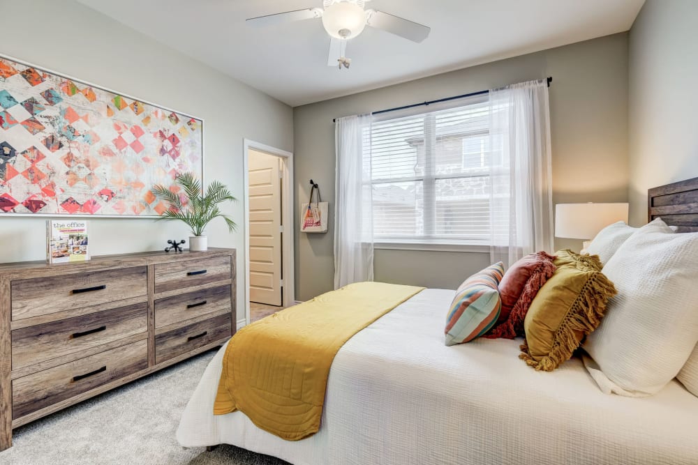 Brightly lit bedroom with ceiling fan to keep you cool at BB Living Harvest in Argyle, Texas