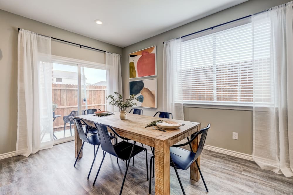 Large dining table with large windows around it and tons of light at Antigua at Lakewood Ranch in Lakewood Ranch, Florida