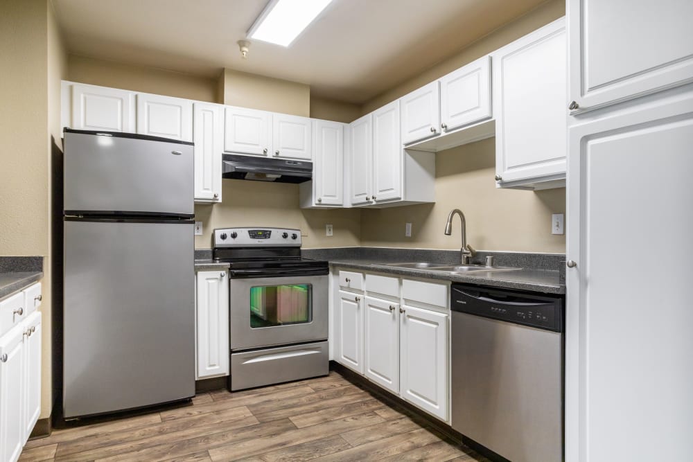 Kitchen with granite-style counter tops at Pebble Cove Apartments in Renton, Washington