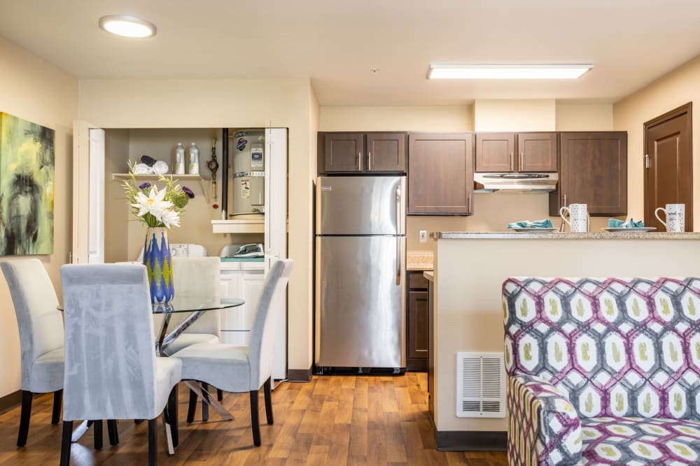 A kitchen complete with modern espresso cabinetry at Pebble Cove Apartments in Renton, Washington