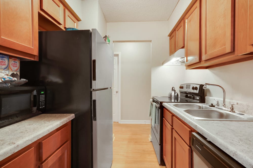 Kitchen with black appliances at Avalon Apartment Homes in Baton Rouge, Louisiana