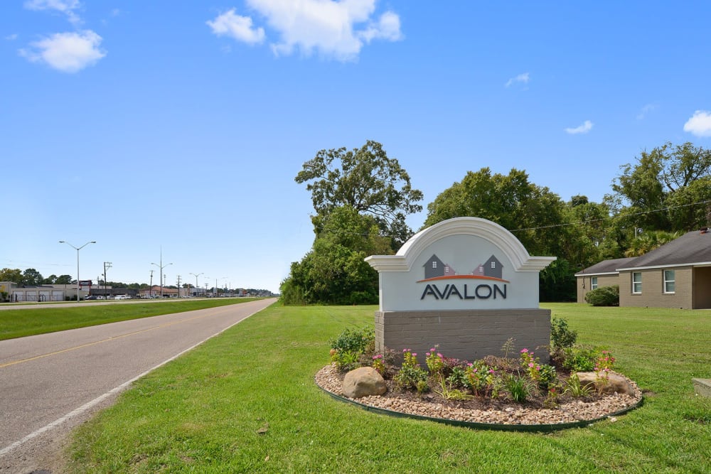 Welcome sign with well maintained grass at Avalon Apartment Homes in Baton Rouge, Louisiana