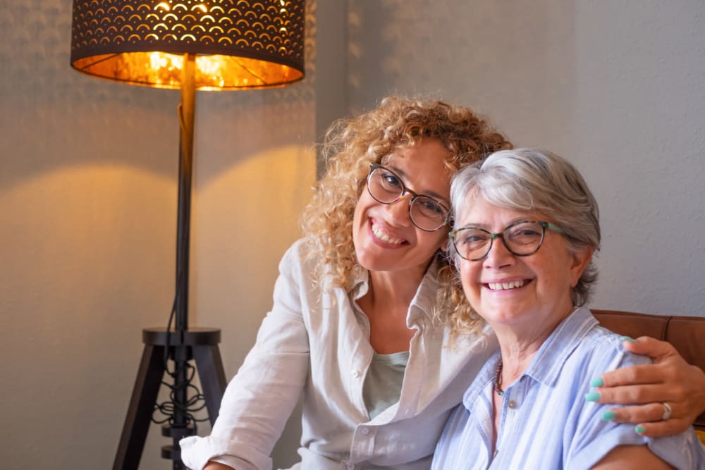 Resident and caregiver smiling together at Lake Park Senior Living in Oakland, California