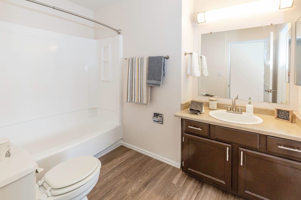 Bathroom with wood-style flooring at Shadowbrook Apartments in West Valley City, Utah