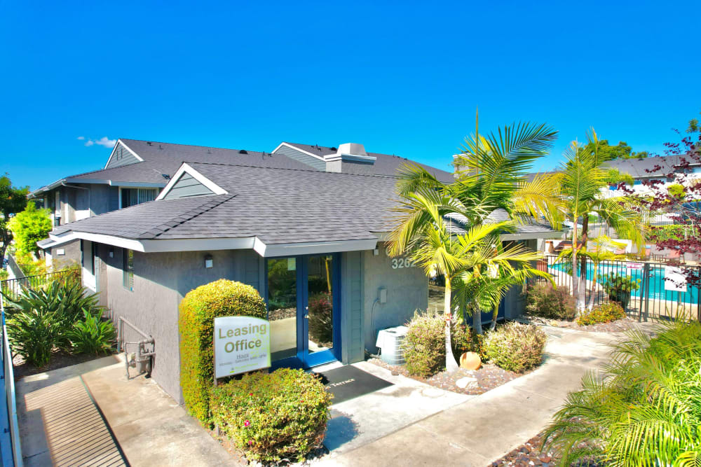 Leasing center entrance surrounded by a lush green landscape at Hillside Terrace Apartments in Lemon Grove, California