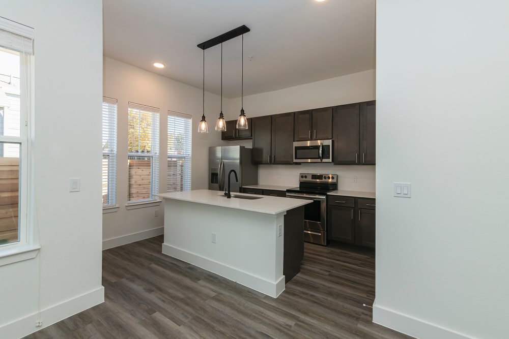 Spacious kitchen with hanging lights at parcHAUS AT CELINA PARKWAY in Celina, Texas