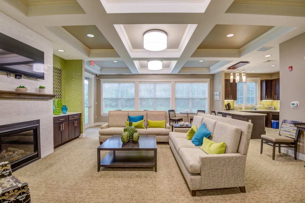 Resident clubhouse with a fireplace at Canal Crossing in Camillus, New York