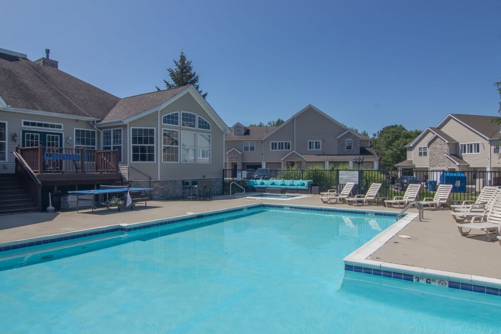 Sparkling swimming pool surrounded by sundeck lounge chairs at Hills of Aberdeen Apartment Homes in Valparaiso, Indiana