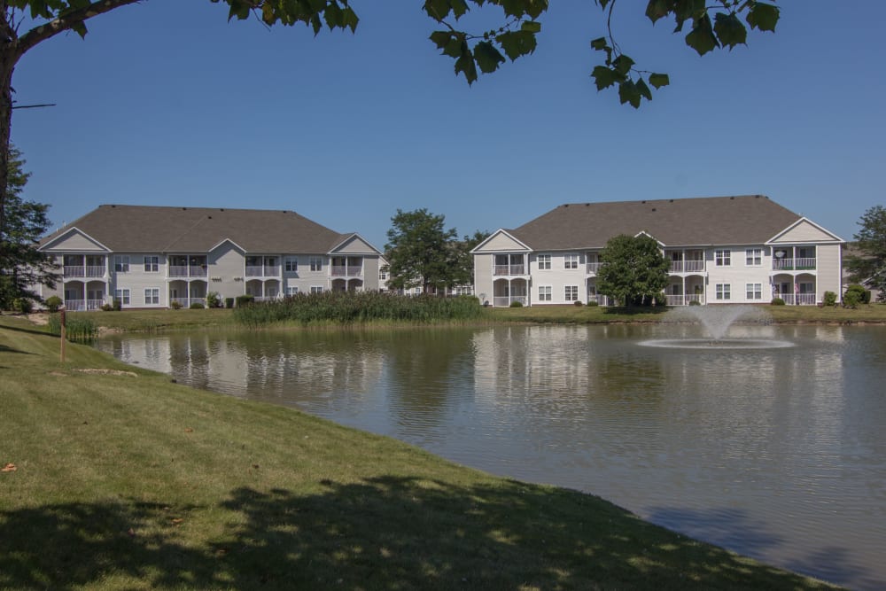 Pond and mature trees on the grounds at Lake Pointe Apartment Homes in Portage, Indiana