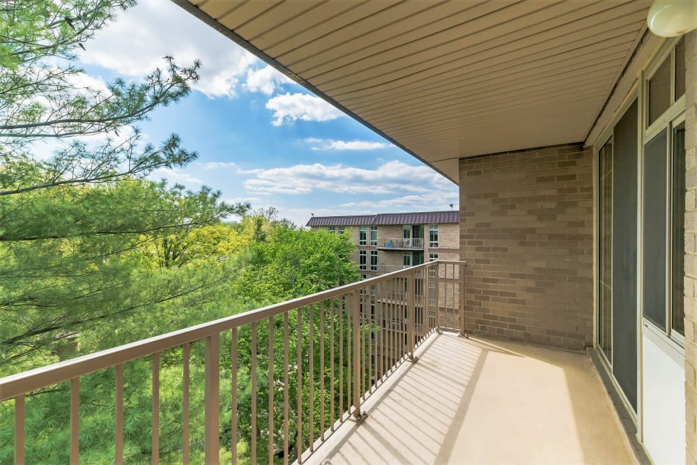 Looking towards homes from a private balcony for a home at Merrill House Apartments in Falls Church, Virginia
