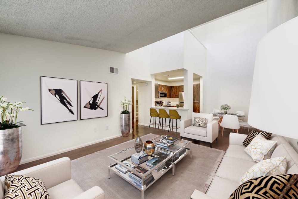 Living room with wood-style flooring at Tuscany Village Apartments in Ontario, California