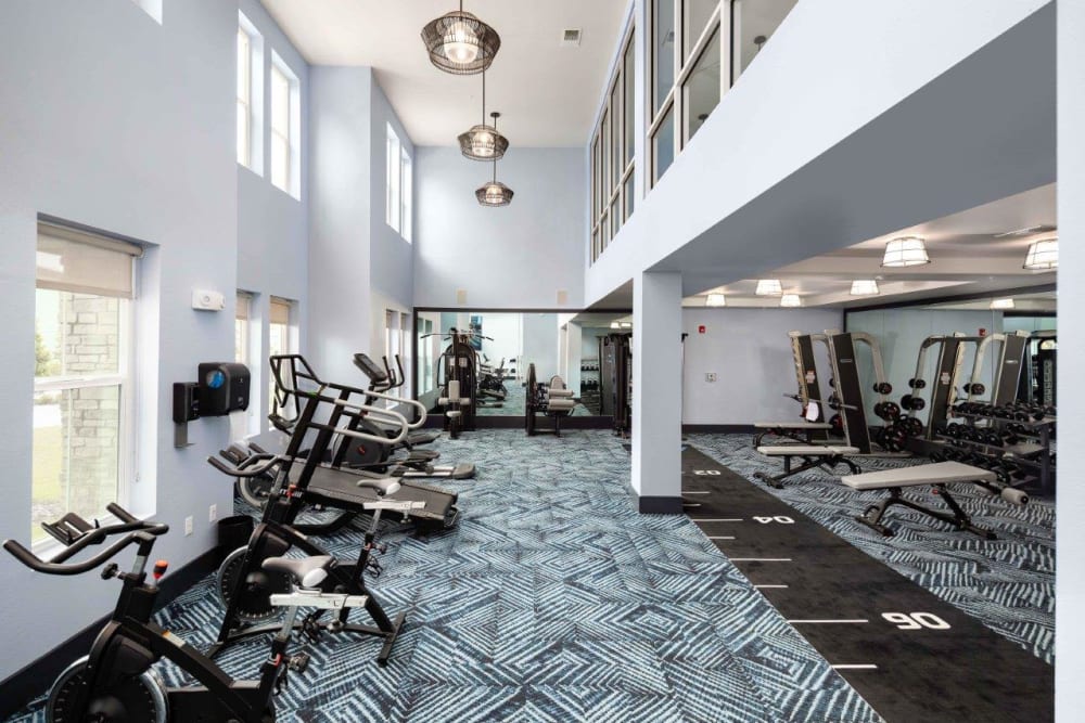 Resident fitness center with tons of equipment for a full workout at The Addison Skyway Marina in St. Petersburg, Florida