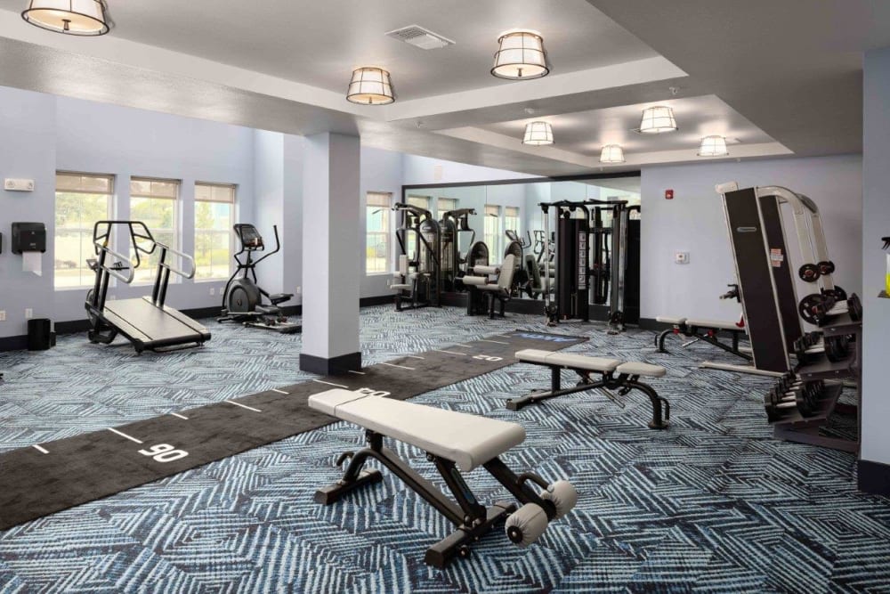 Full fitness center with free-weights and benches to lift with at The Addison Skyway Marina in St. Petersburg, Florida