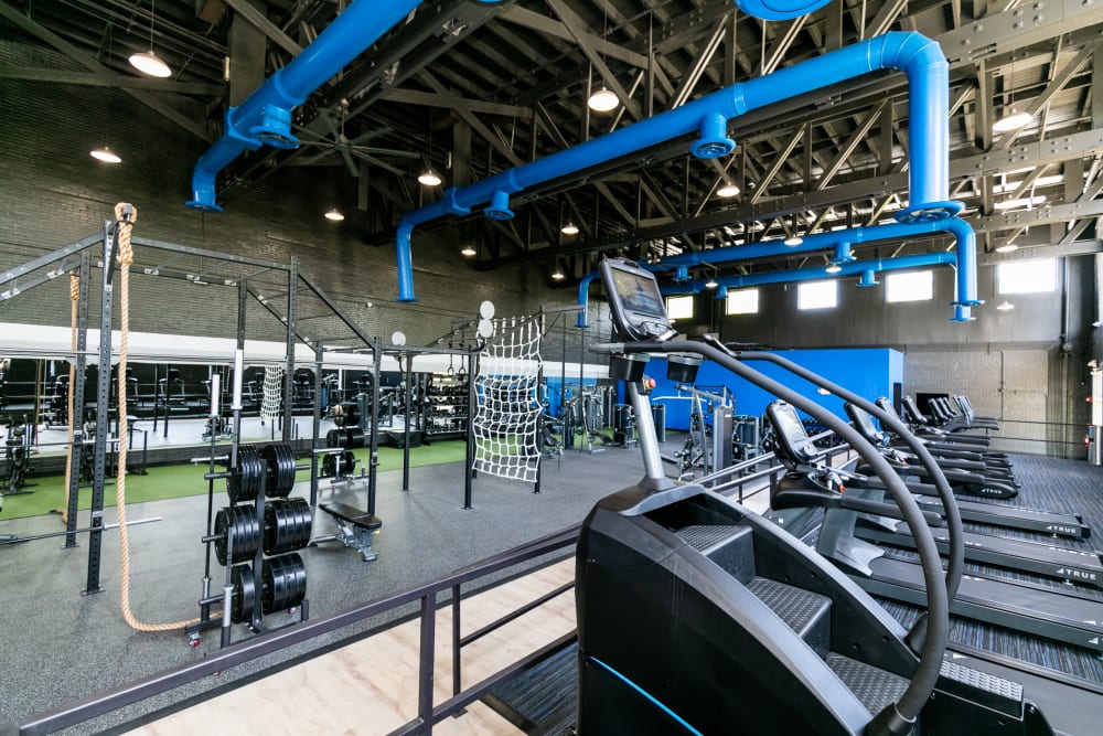  Large fitness center with heavy free weights and other modern workout equipment at Lofts at Riverwalk in Columbus, Georgia