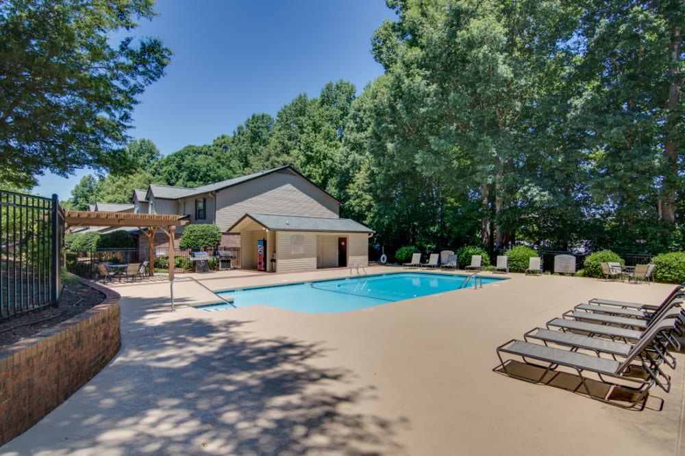 Swimming pool with lounge chairs at Foundry Townhomes in Simpsonville, South Carolina