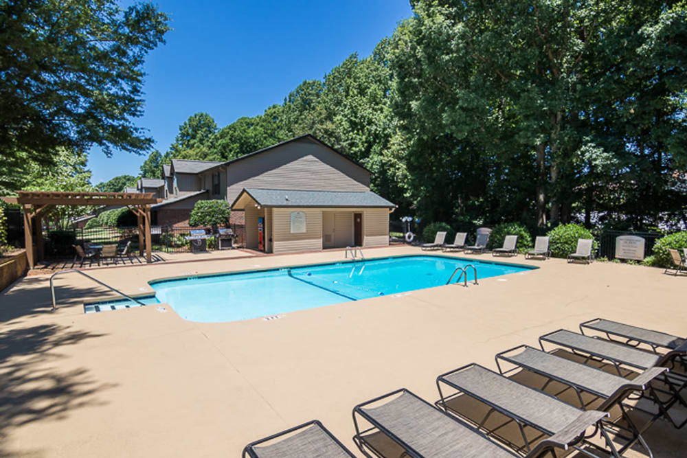 Luxurious swimming pool with lounge chairs at Foundry Townhomes in Simpsonville, South Carolina