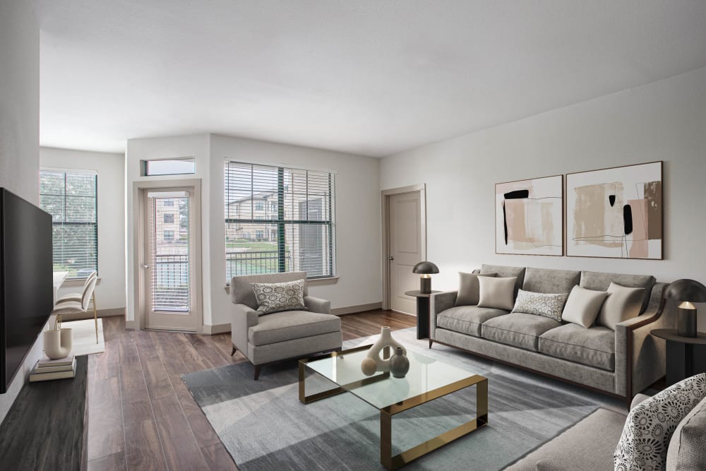 Model living room with wood flooring at Olympus Falcon Landing in Katy, Texas