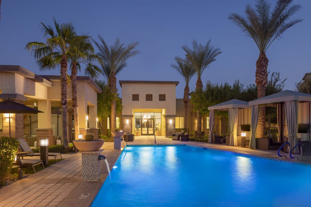 Resort-style swimming pool surrounded by palm trees at Cadia Crossing in Gilbert, Arizona