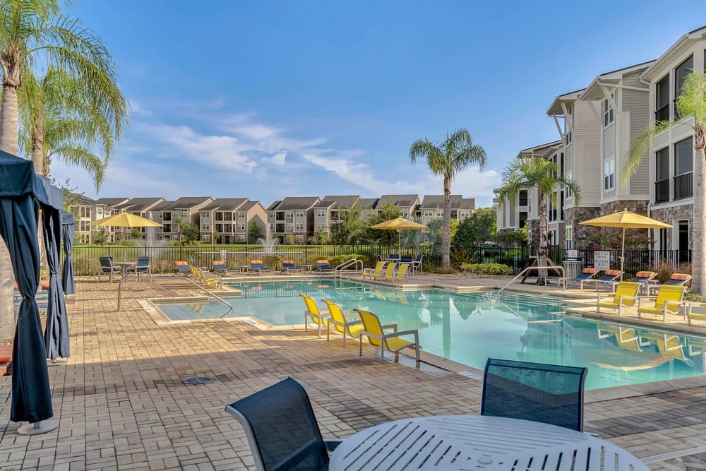 Large in-ground pool with seating at Art Avenue Apartment Homes in Orlando, Florida