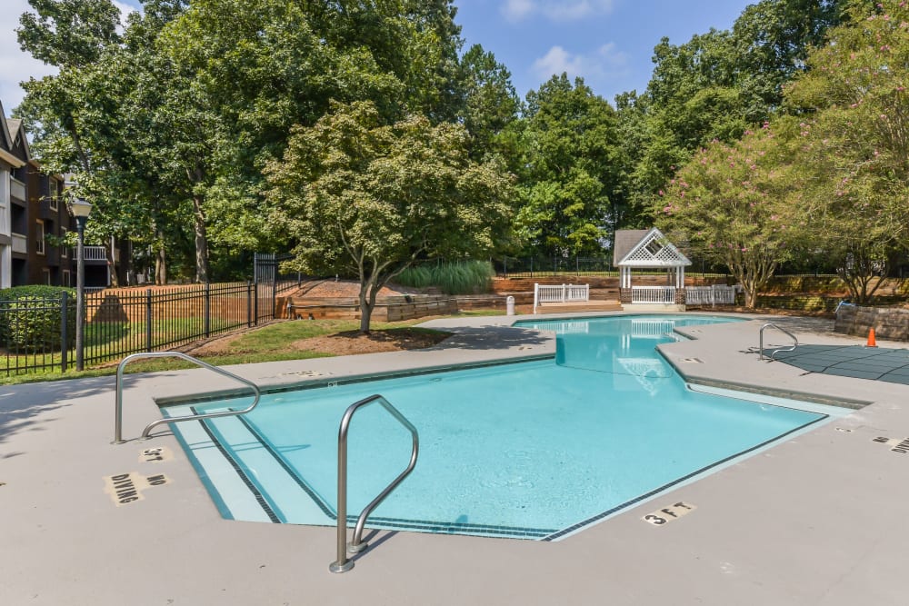 Swimming pool with gazebo behind it at The Oasis at Regal Oaks in Charlotte, North Carolina