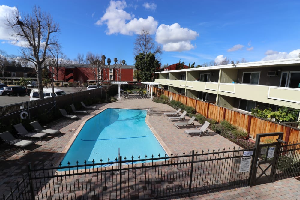 Chaise lounges by the pool at Parkway Apartment Homes in Fremont, California