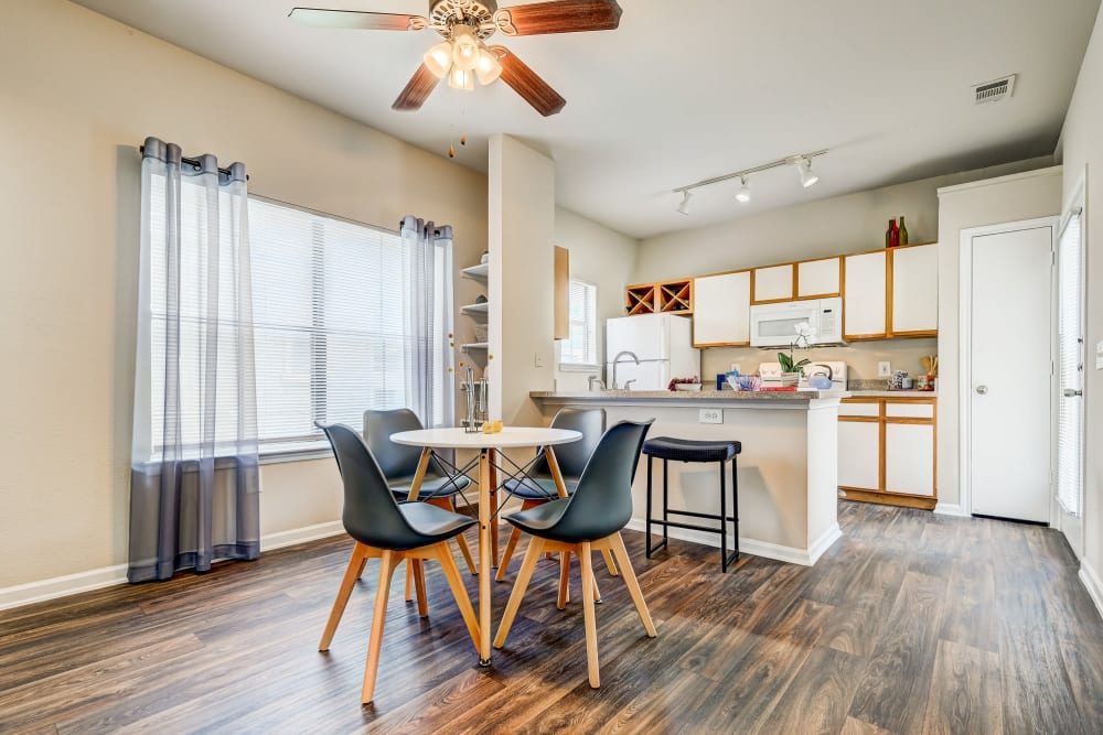 Well lit dining room with a gorgeous window view located at Legacy of Cedar Hill Apartments & Townhomes in Cedar Hill, Texas