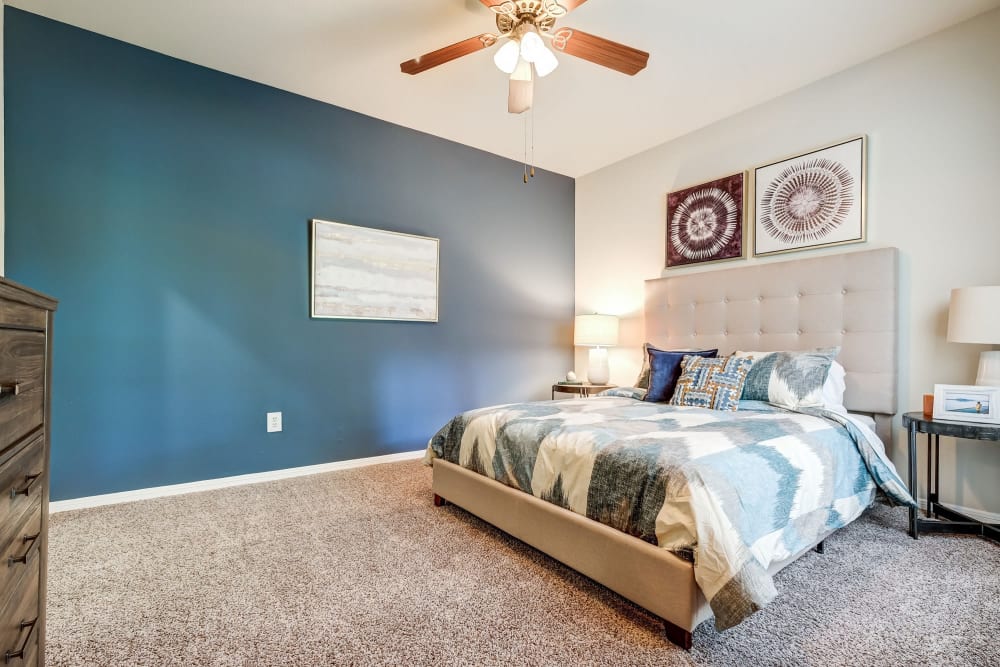 Luxurious and spacious bedroom with access to natural lighting at Legacy of Cedar Hill Apartments & Townhomes in Cedar Hill, Texas