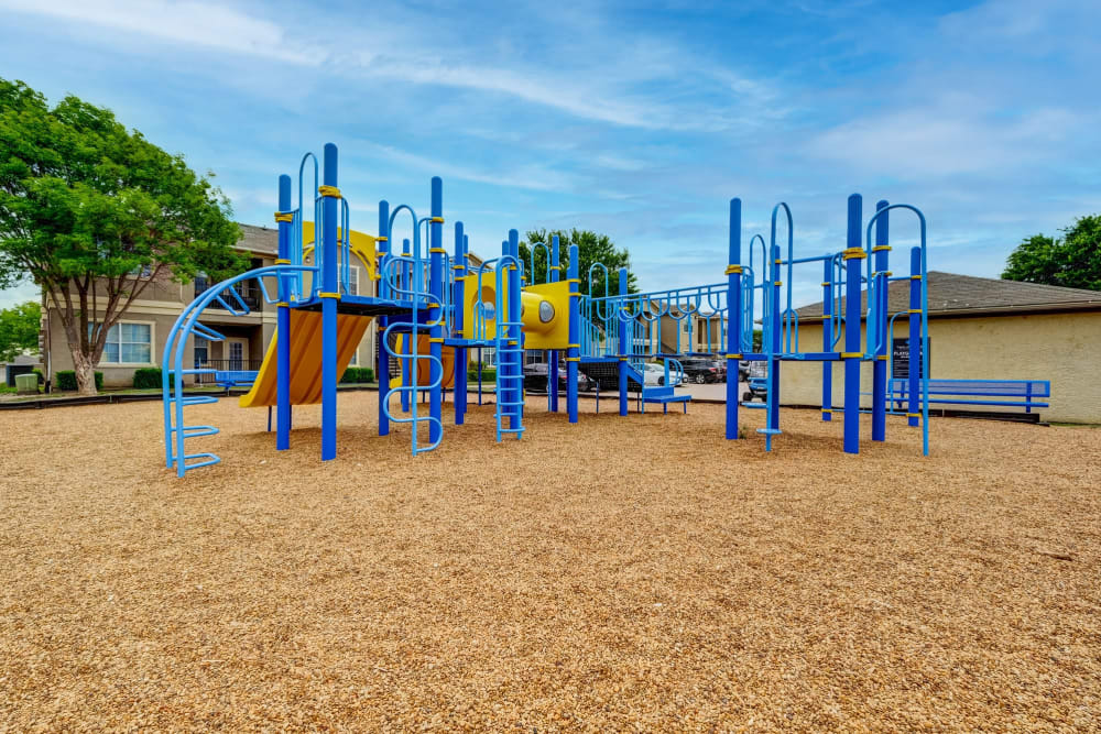 Apartments with a Playground equipped with a slide located at Legacy of Cedar Hill Apartments & Townhomes in Cedar Hill, Texas