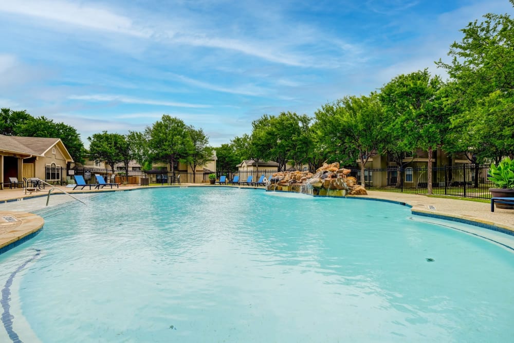 Beautiful blue sky with a luxurious pool Legacy of Cedar Hill Apartments & Townhomes in Cedar Hill, Texas