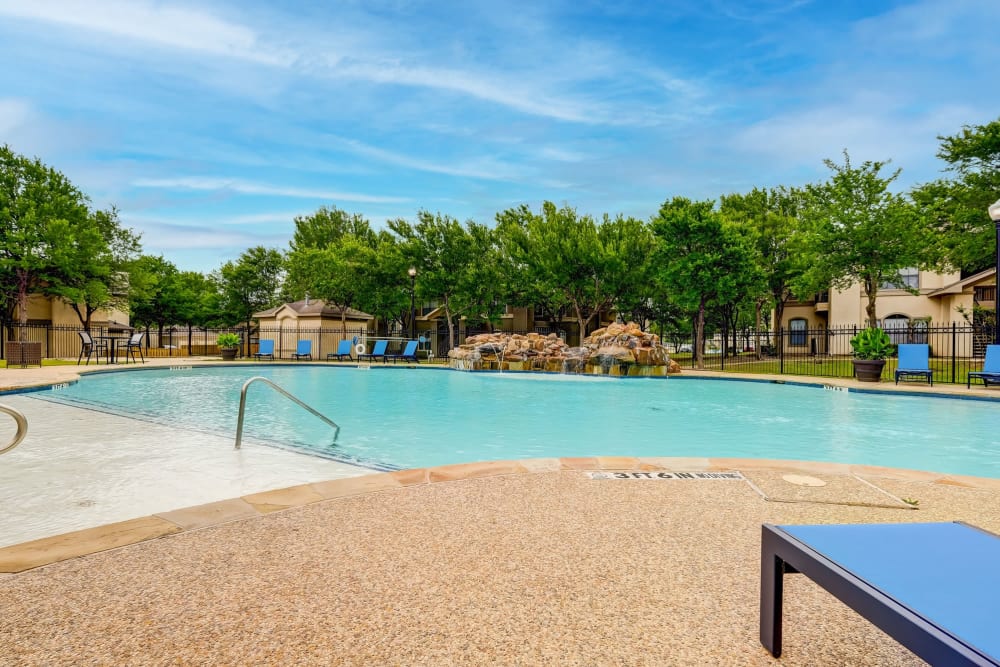 Beautiful blue sky with a luxurious pool Legacy of Cedar Hill Apartments & Townhomes in Cedar Hill, Texas